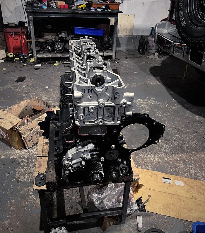 A stripped engine on the stand during a rebuild